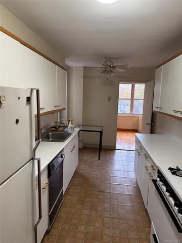 a large kitchen with a stove a sink dishwasher and a refrigerator