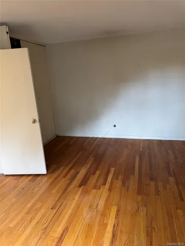 a view of room with wooden floor