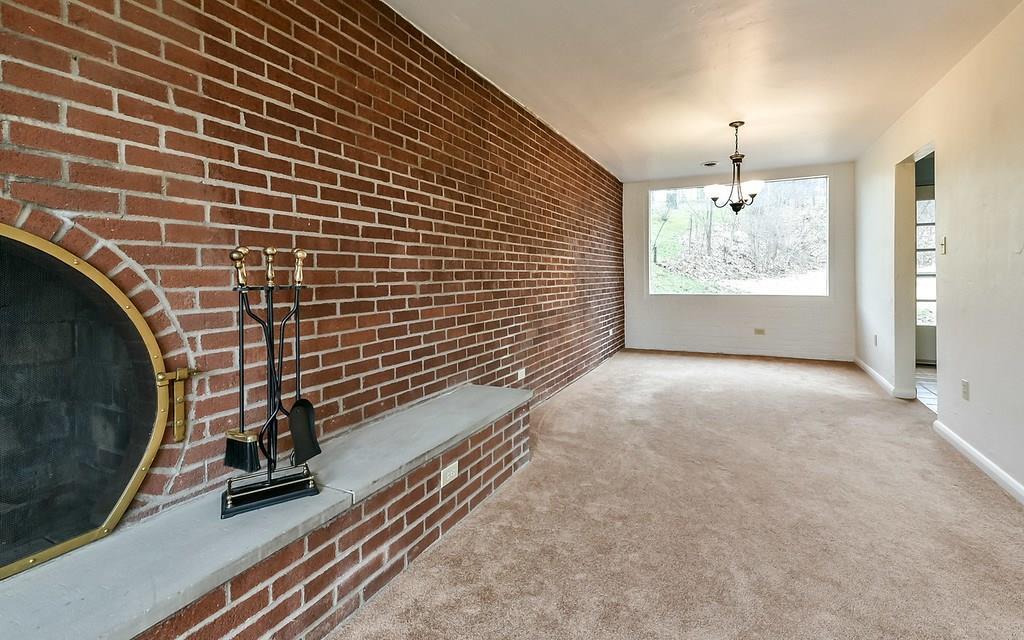 Great view of extraordinary exposed brick wall highlighting the main floor interior from front-To-back of the house!