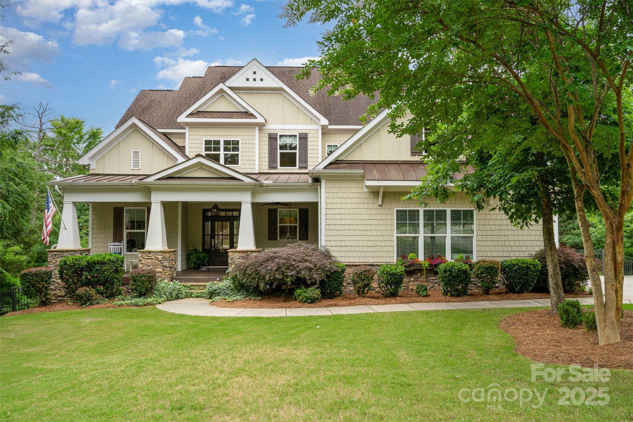 a front view of a house with a yard and porch