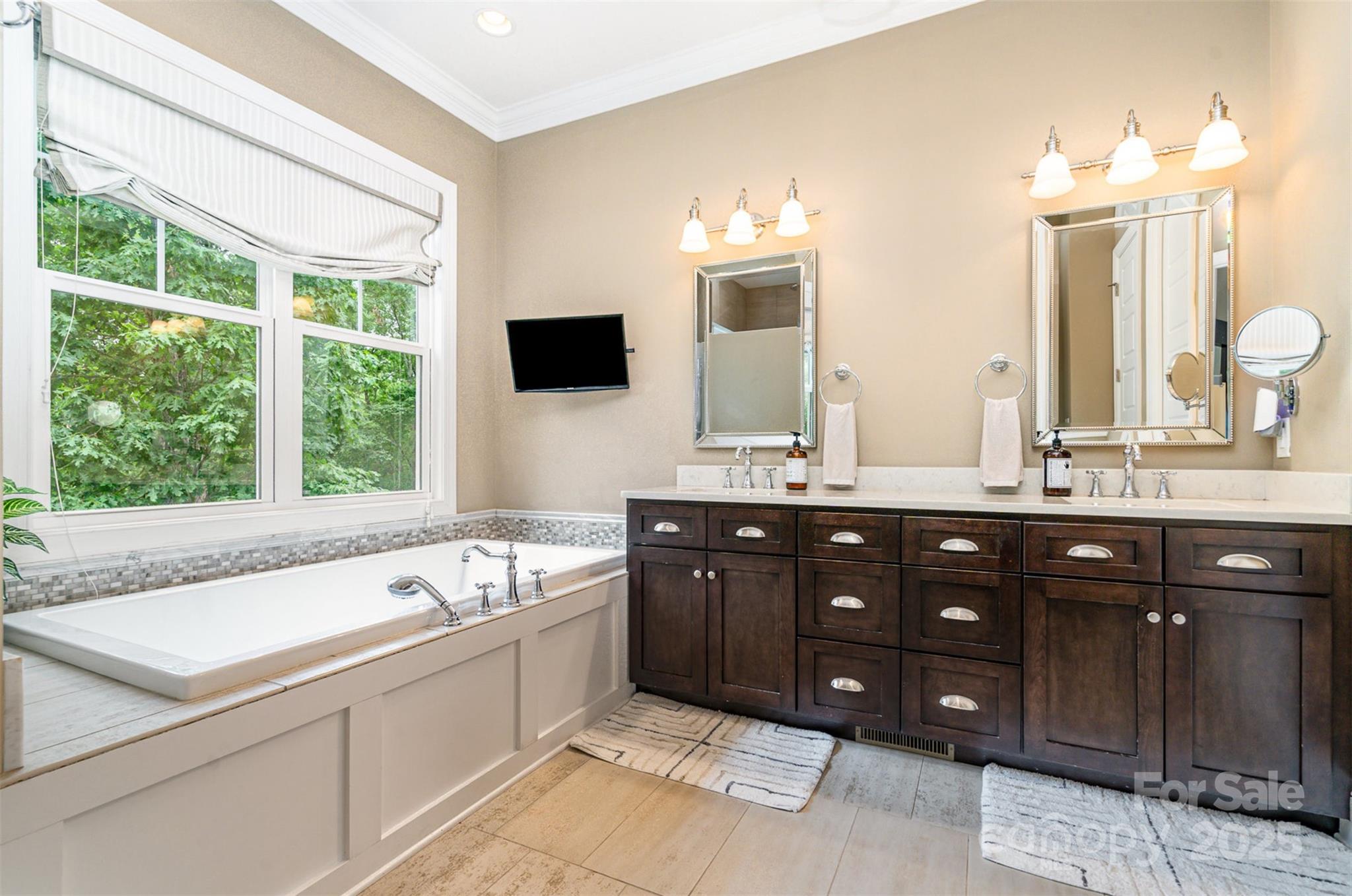 6873 Pine Moss Lane Clover, SC 29710 - Photo 17 of 46 a spacious bathroom with a tub sink and mirror