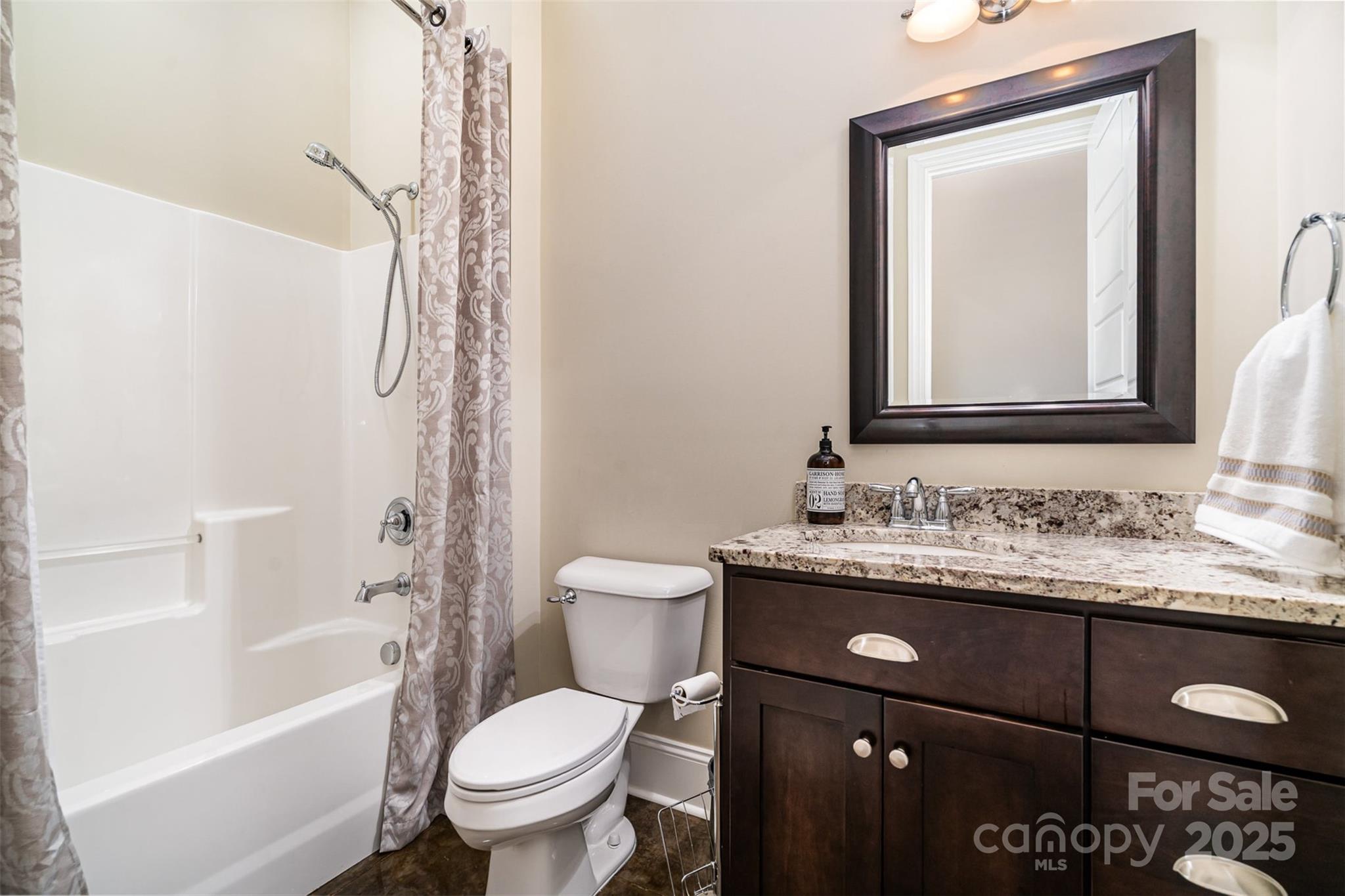 6873 Pine Moss Lane Clover, SC 29710 - Photo 36 of 46 a bathroom with a granite countertop toilet sink and mirror