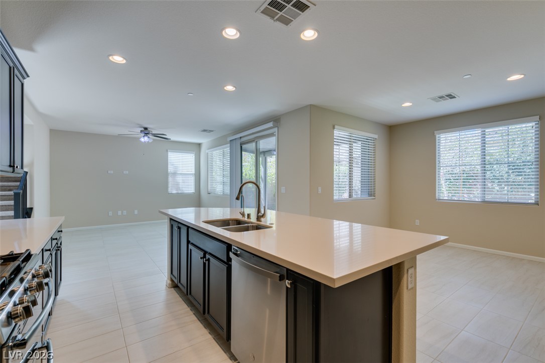 2549 Sable Ridge Street Henderson, NV 89044 - Photo 31 of 48 A spacious kitchen island with dual sinks anchors this well-lit open-concept living area.