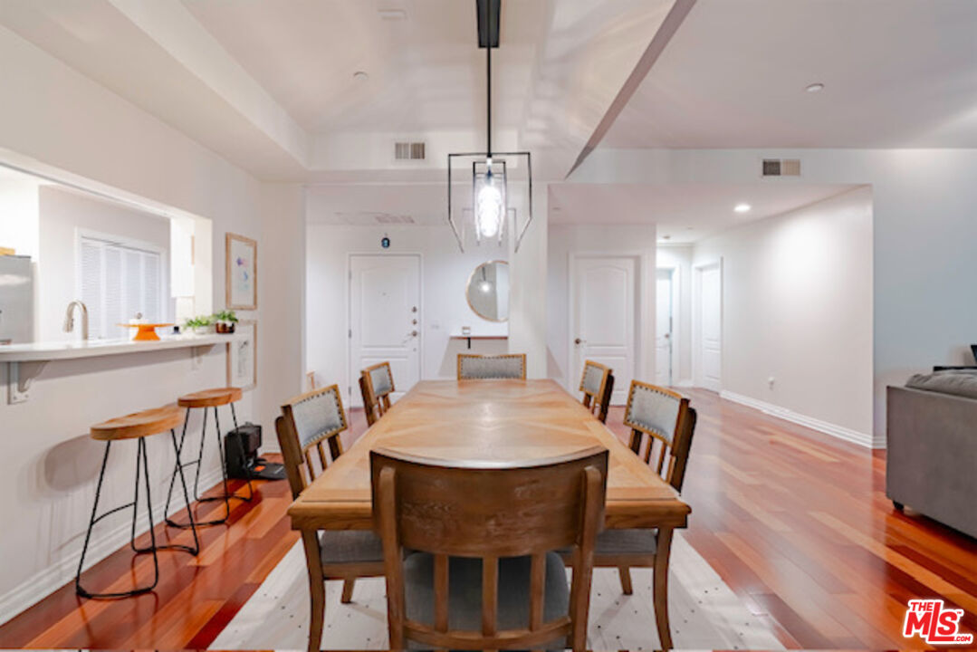 956 South Wilton Place, Unit 305 Los Angeles, CA 90019 - Photo 13 of 18 a view of a dining room with furniture and wooden floor