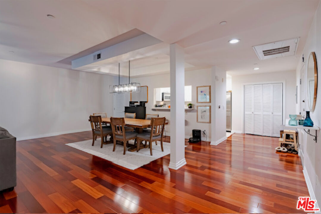 956 South Wilton Place, Unit 305 Los Angeles, CA 90019 - Photo 17 of 18 a living room with furniture dining table and a refrigerator