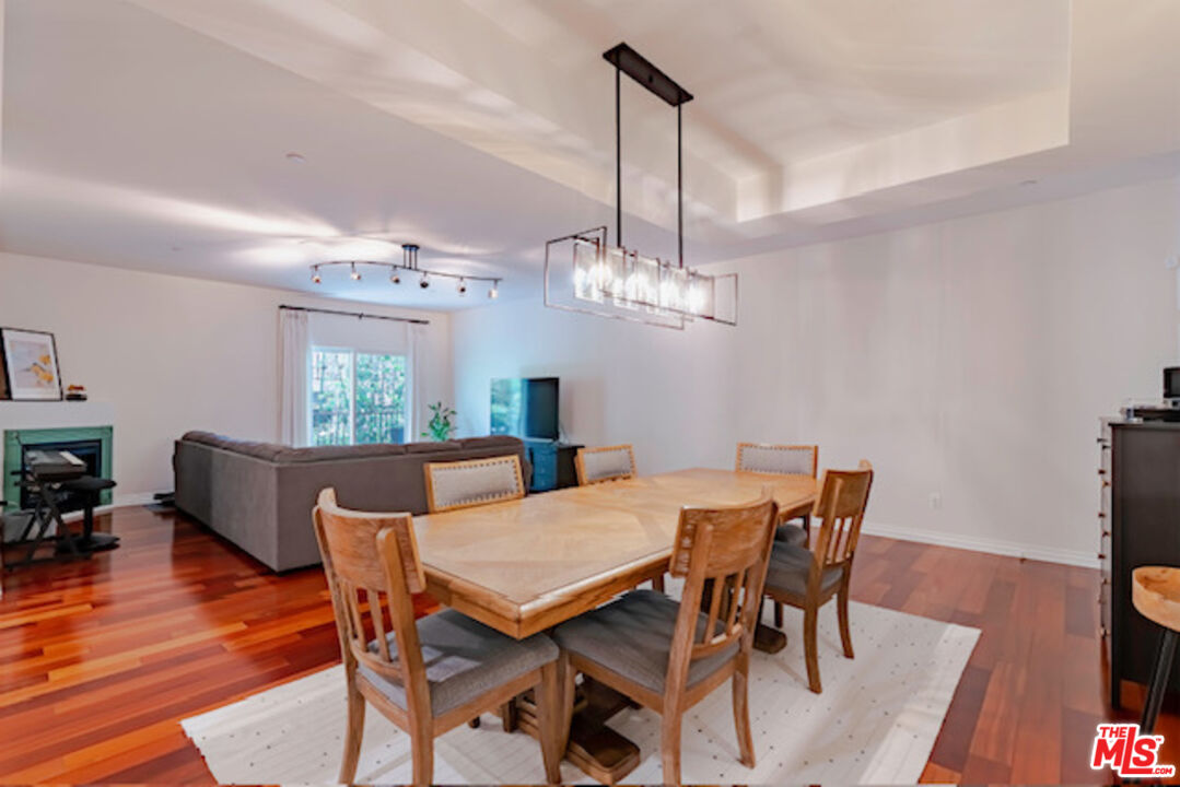 956 South Wilton Place, Unit 305 Los Angeles, CA 90019 - Photo 2 of 18 a view of a dining room with furniture window and wooden floor