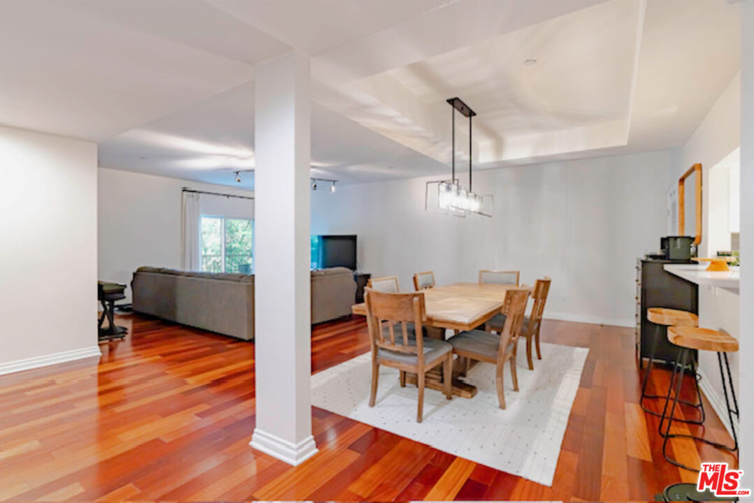 956 South Wilton Place, Unit 305 Los Angeles, CA 90019 - Photo 3 of 18 a view of a dining room with furniture and wooden floor