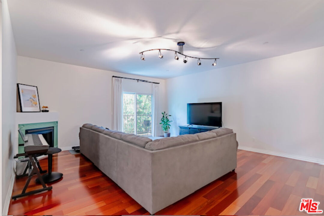 956 South Wilton Place, Unit 305 Los Angeles, CA 90019 - Photo 4 of 18 a living room with furniture and a flat screen tv