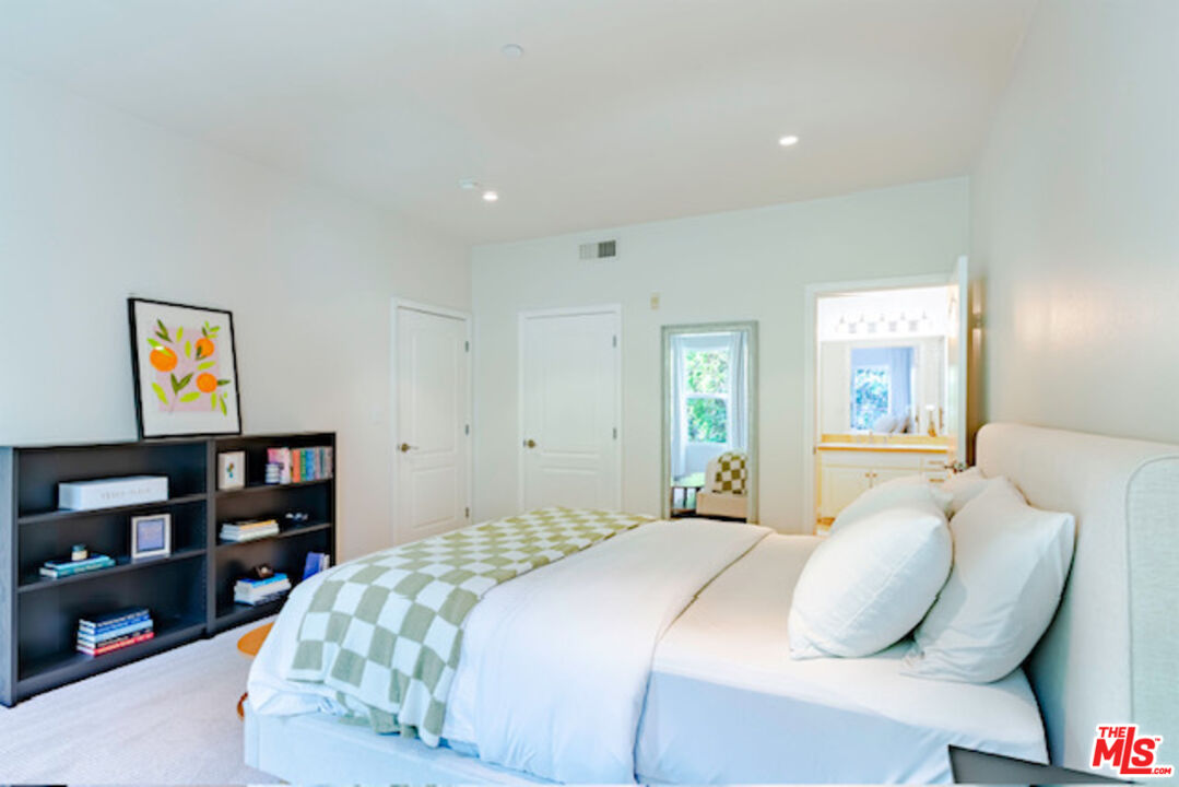 956 South Wilton Place, Unit 305 Los Angeles, CA 90019 - Photo 6 of 18 a bedroom with a bed and closet