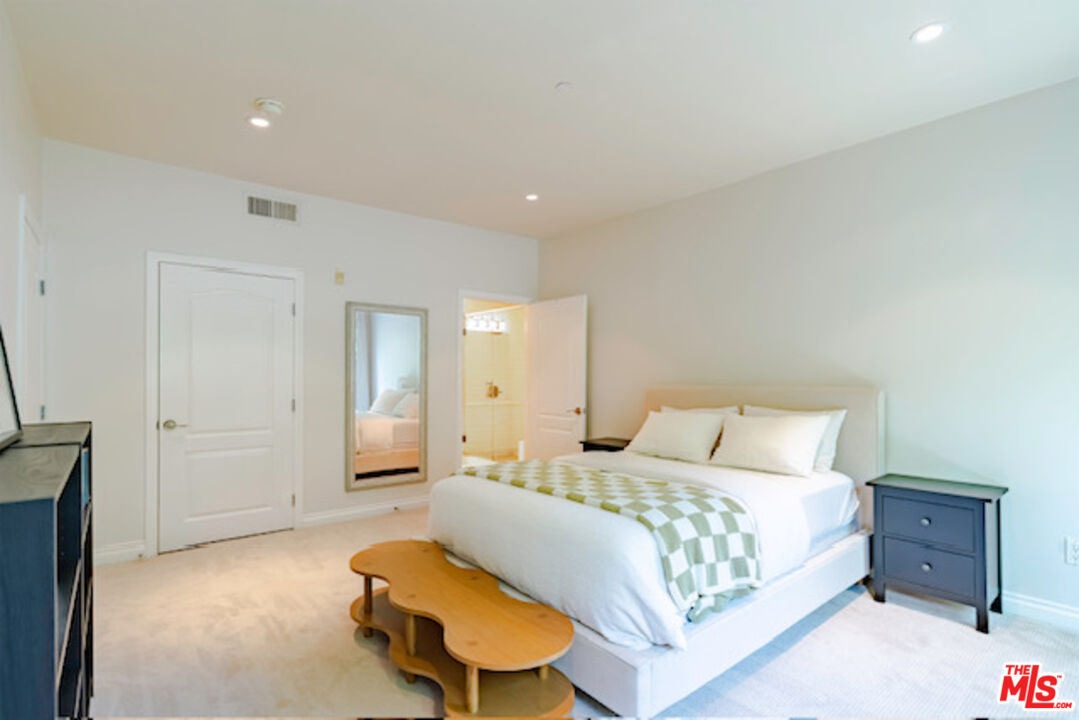 956 South Wilton Place, Unit 305 Los Angeles, CA 90019 - Photo 10 of 18 a bedroom with a bed and a couch