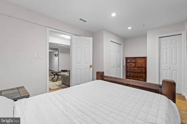 a bedroom with a bed and a dresser