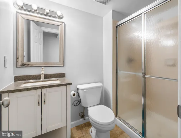 a bathroom with a toilet a sink and a mirror