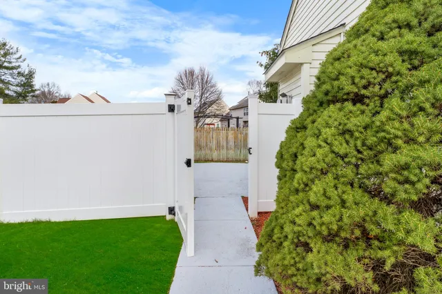 a pathway of a house with a yard