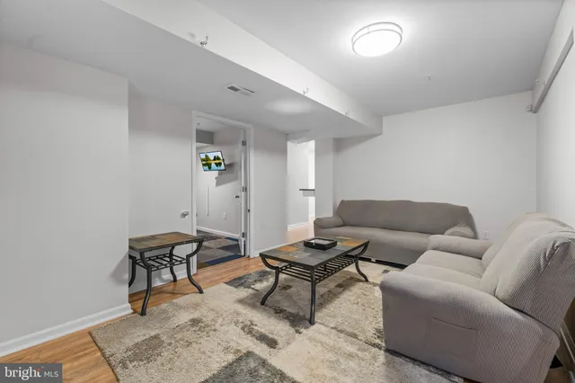 a living room with furniture and a rug