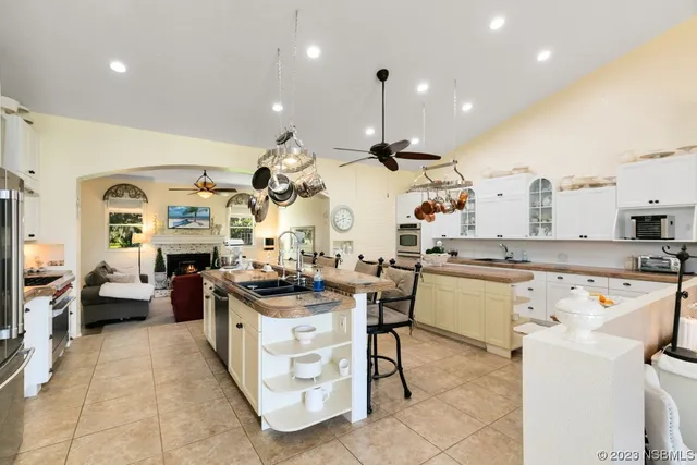 a kitchen with stainless steel appliances kitchen island granite countertop a sink and cabinets