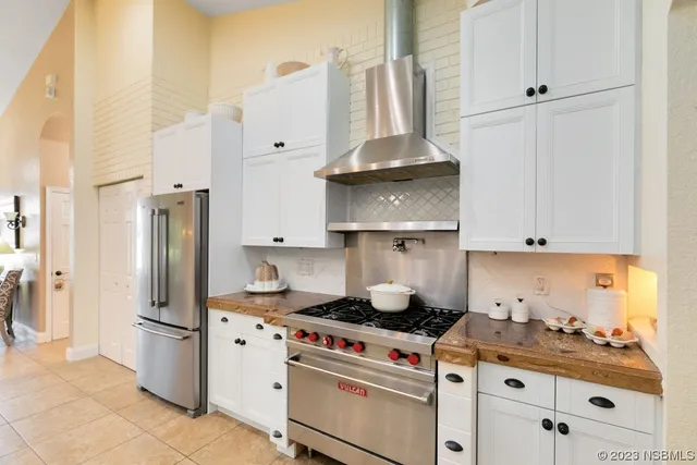 a kitchen with stainless steel appliances a stove and refrigerator