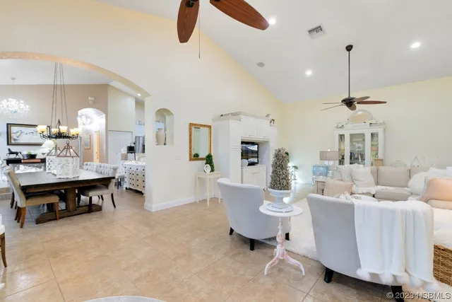 a living room with furniture and a kitchen
