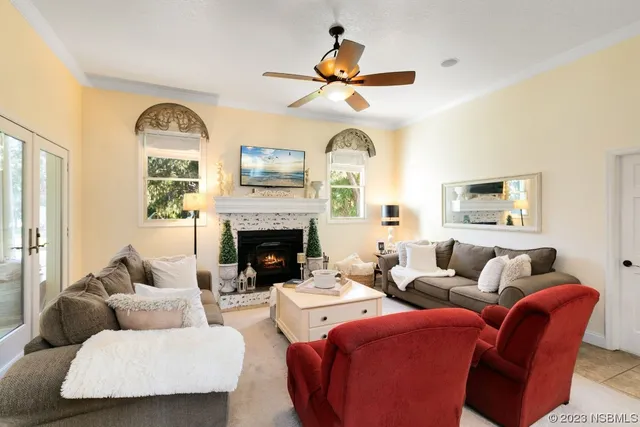 a living room with furniture a fireplace and a large window