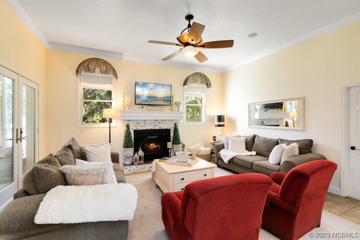 1780 Old Mission Road Edgewater, FL 32132 - Photo 18 of 55 a living room with furniture a fireplace and a large window