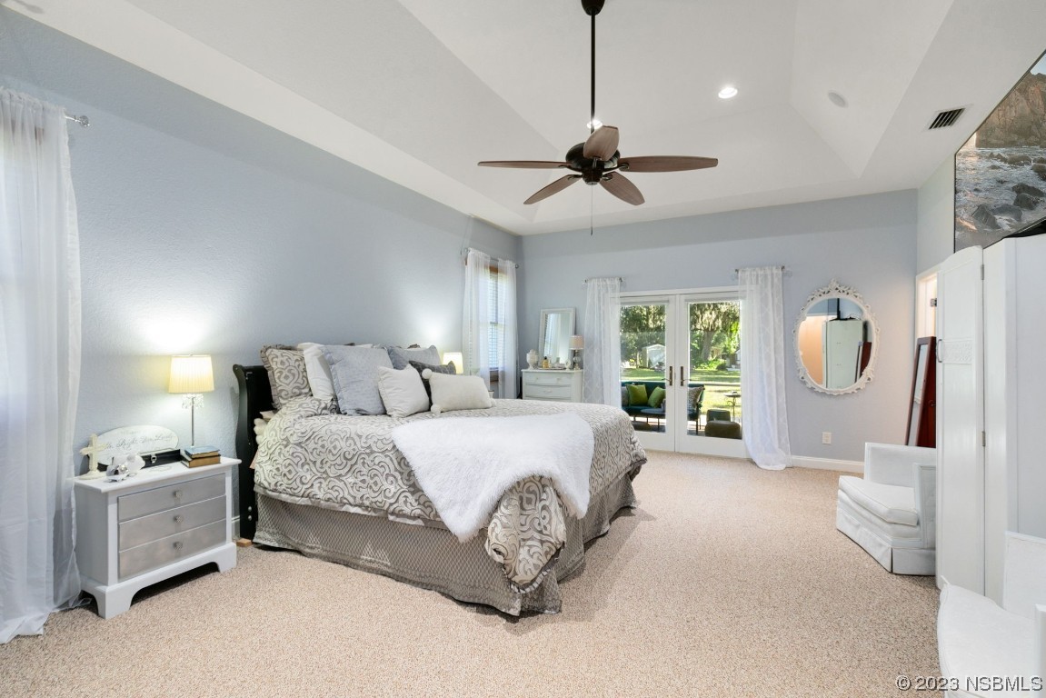 1780 Old Mission Road Edgewater, FL 32132 - Photo 19 of 55 a spacious bedroom with a bed mirror and window