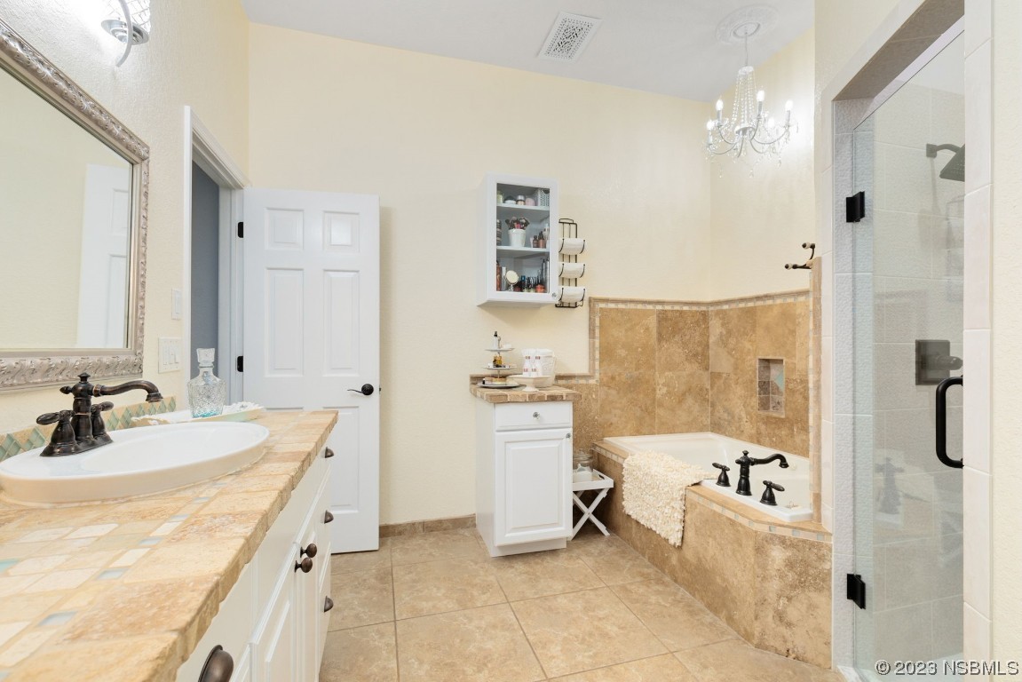 1780 Old Mission Road Edgewater, FL 32132 - Photo 21 of 55 a bathroom with a bathtub sink and mirror