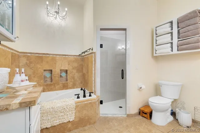 a bathroom with a granite countertop sink a toilet and shower