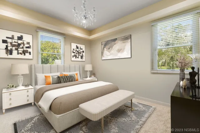 a bedroom with a bed and a chandelier