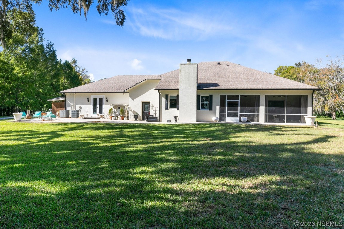 1780 Old Mission Road Edgewater, FL 32132 - Photo 32 of 55 a front view of a house with a garden