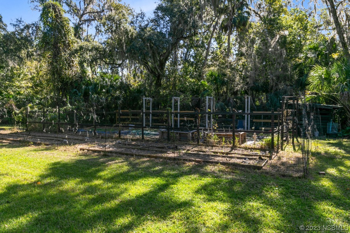 1780 Old Mission Road Edgewater, FL 32132 - Photo 39 of 55 a view of swimming pool with a bench and trees