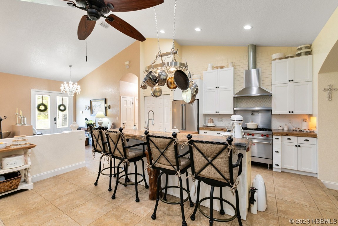 1780 Old Mission Road Edgewater, FL 32132 - Photo 9 of 55 a kitchen with stainless steel appliances a table chairs sink and stove top oven