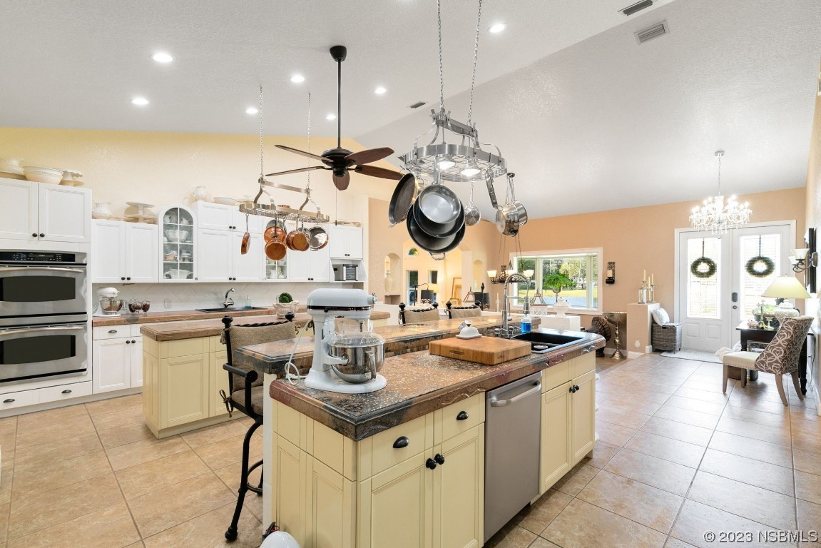 1780 Old Mission Road Edgewater, FL 32132 - Photo 10 of 55 a kitchen with a sink a stove cabinets and living room view