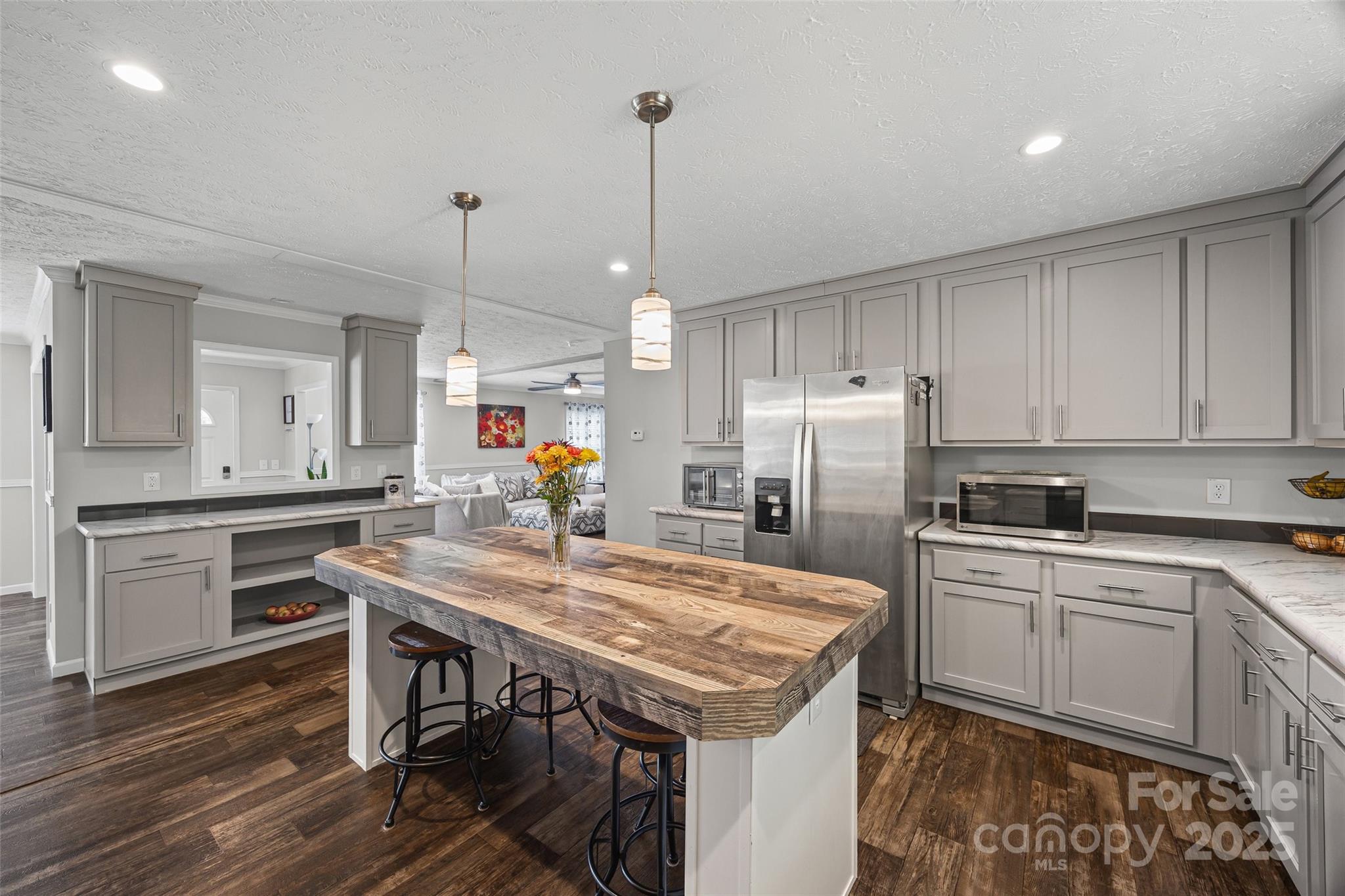 a kitchen with a table chairs sink and cabinets