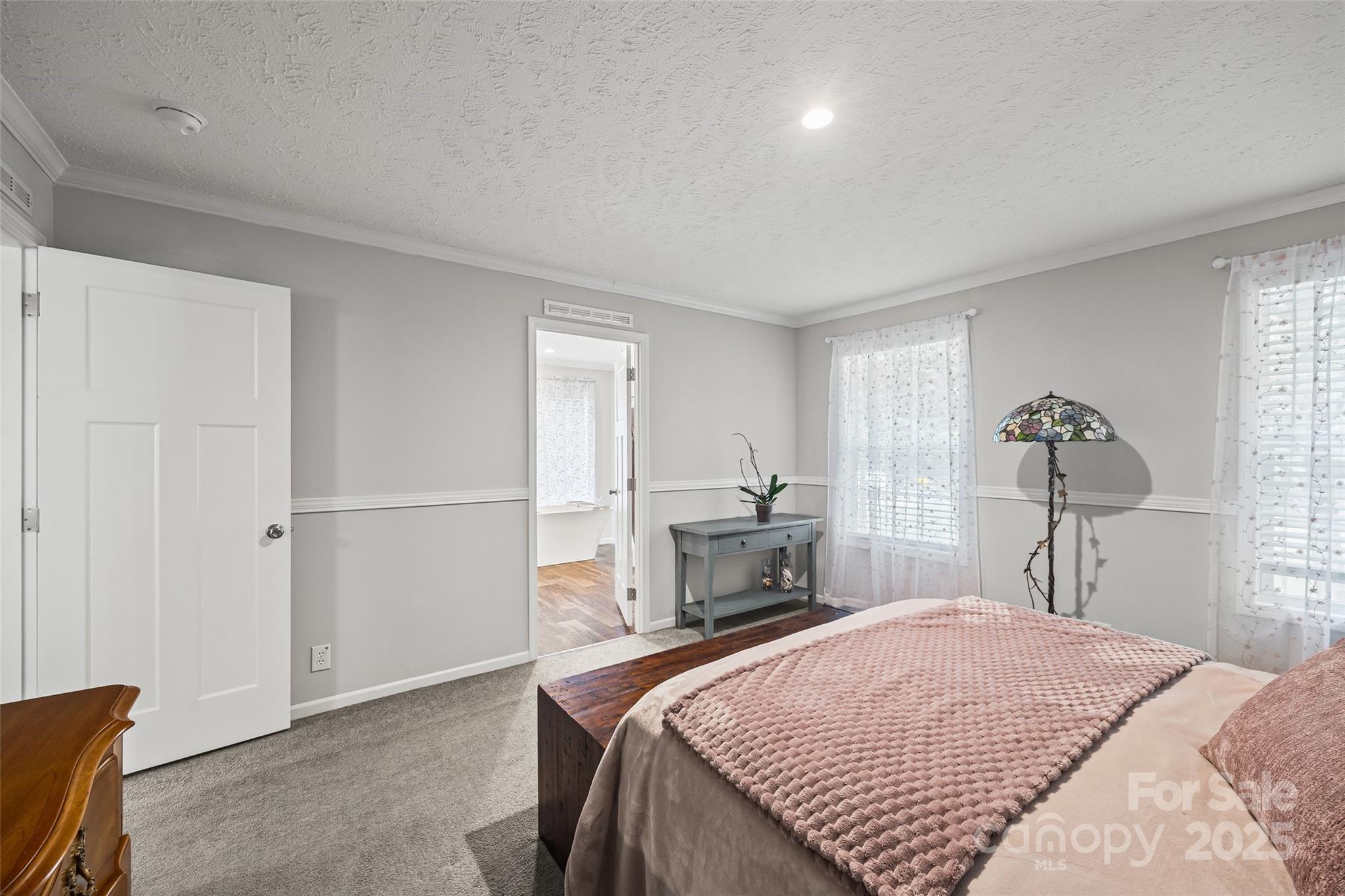 1804 Tom Joye Road Clover, SC 29710 - Photo 12 of 28 a bedroom with a bed and a chandelier