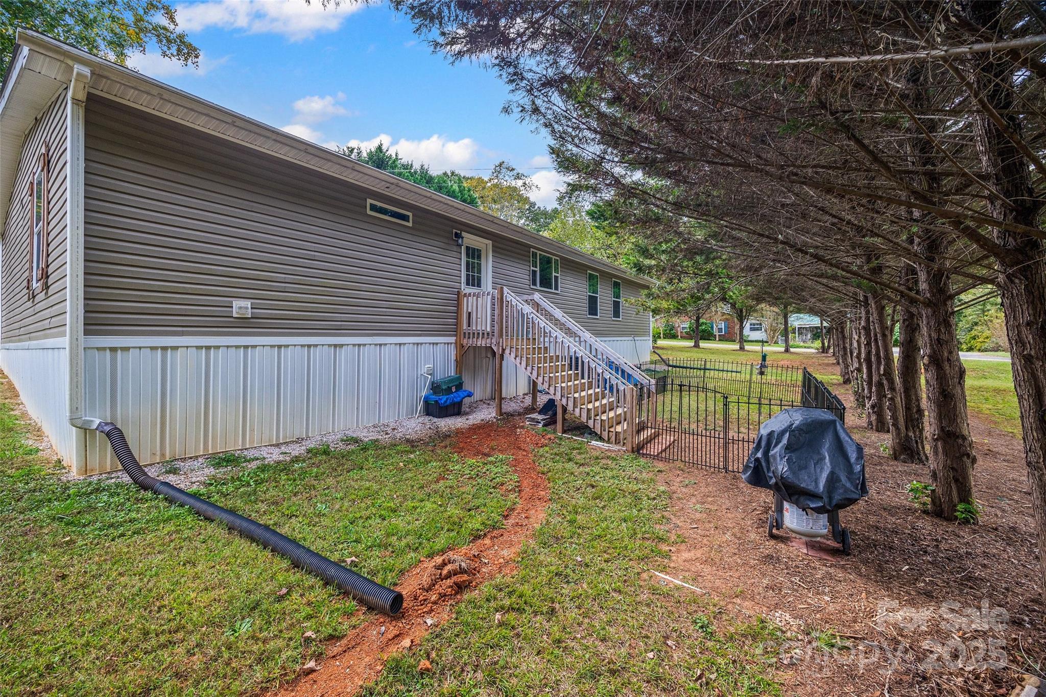 1804 Tom Joye Road Clover, SC 29710 - Photo 24 of 28 a backyard of a house with barbeque oven table and chairs