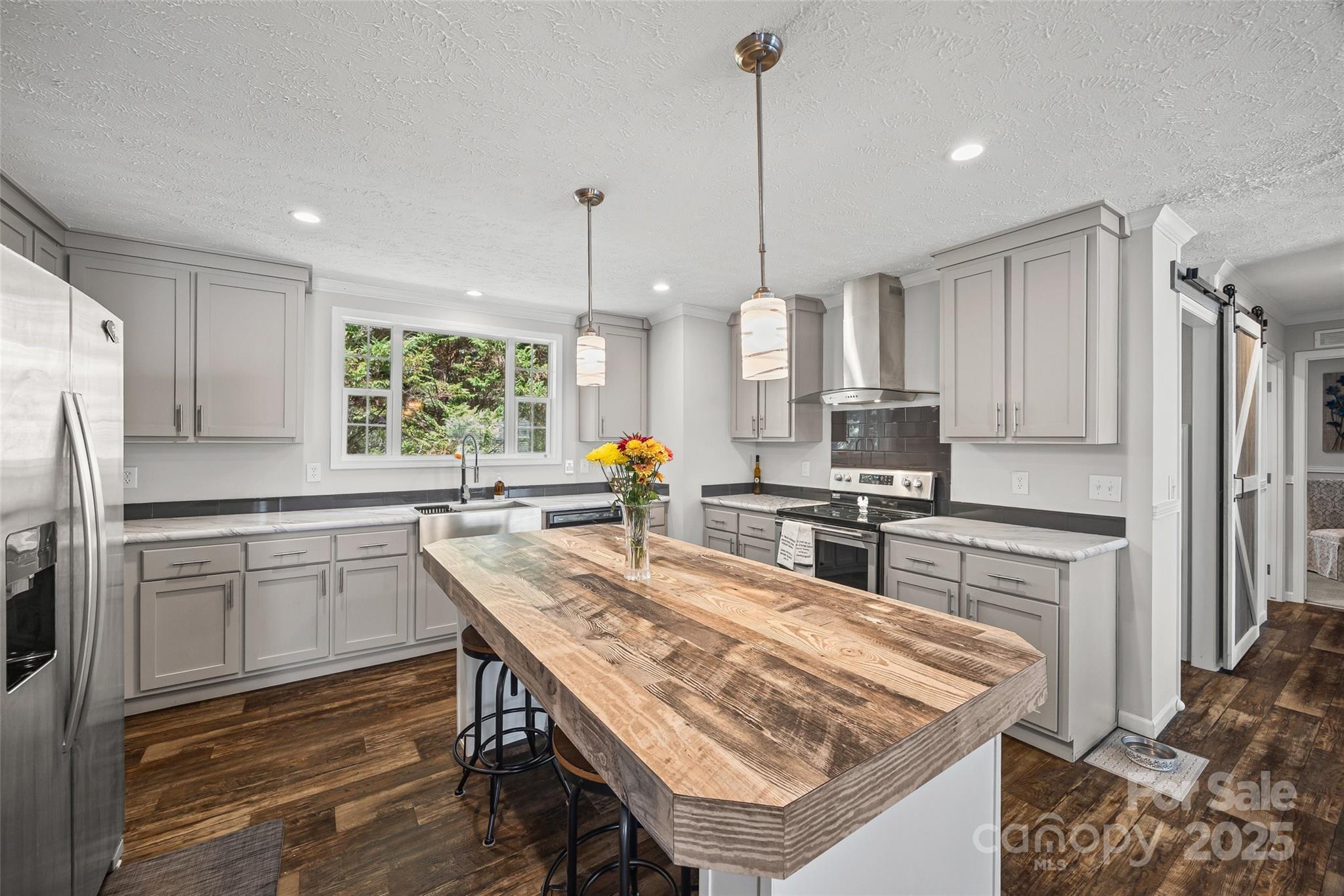 1804 Tom Joye Road Clover, SC 29710 - Photo 9 of 28 a kitchen with stainless steel appliances granite countertop a sink a stove a refrigerator cabinets and chairs