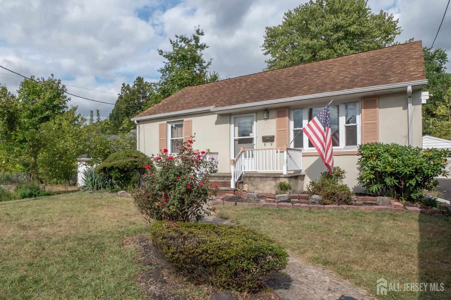 a front view of house with yard and trees around