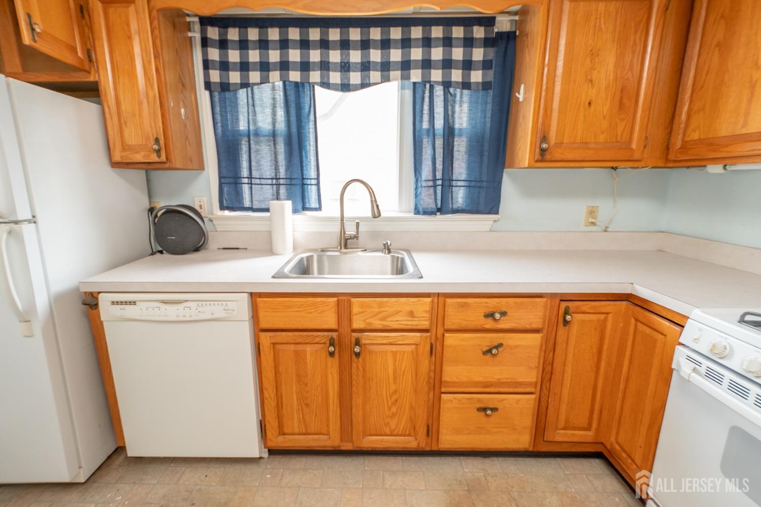 203 New Market Road Dunellen, NJ 08812 - Photo 12 of 44 a kitchen with stainless steel appliances granite countertop a sink and a cabinets