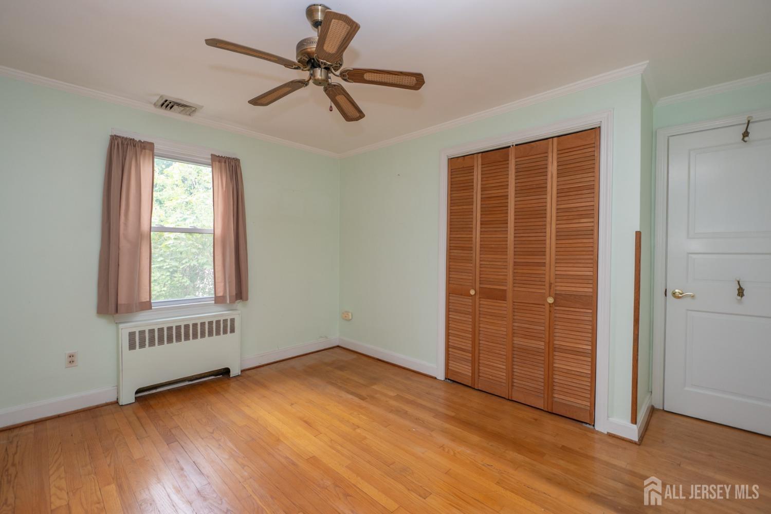 203 New Market Road Dunellen, NJ 08812 - Photo 22 of 44 a view of an empty room with a window and wooden floor