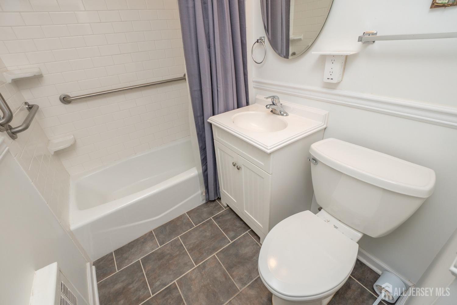 203 New Market Road Dunellen, NJ 08812 - Photo 24 of 44 a white toilet sitting next to a bathroom sink