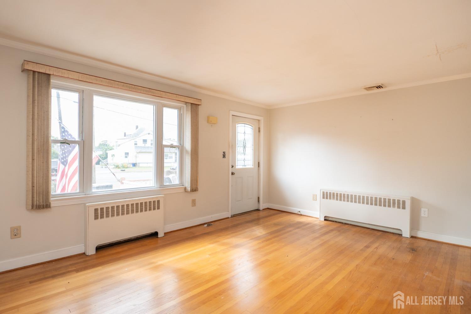 203 New Market Road Dunellen, NJ 08812 - Photo 3 of 44 an empty room with a empty space and windows