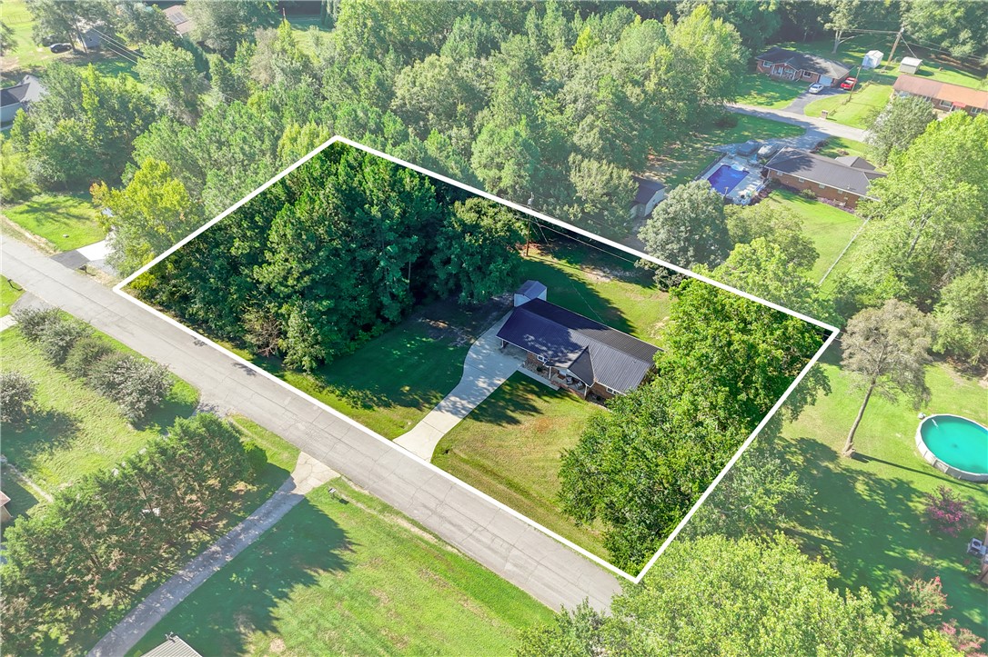 207 Ridgecrest Drive Williamston, SC 29697 - Photo 19 of 22 Mature trees surround this private property featuring a spacious yard and concrete driveway.