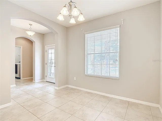 a kitchen with stainless steel appliances granite countertop a refrigerator a sink a stove top oven and a counter space