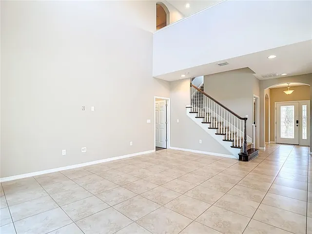 a view of empty room with wooden floor and entryway