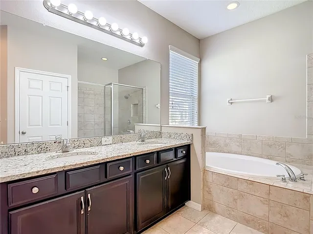 an aerial view of residential houses with outdoor space and ocean view