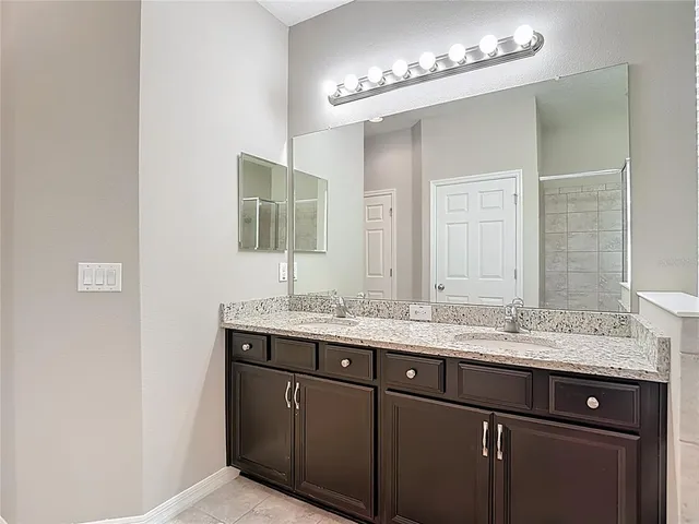 an aerial view of a house with a yard basket ball court and outdoor seating