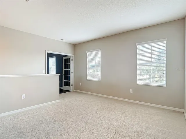 an aerial view of a swimming pool with outdoor seating