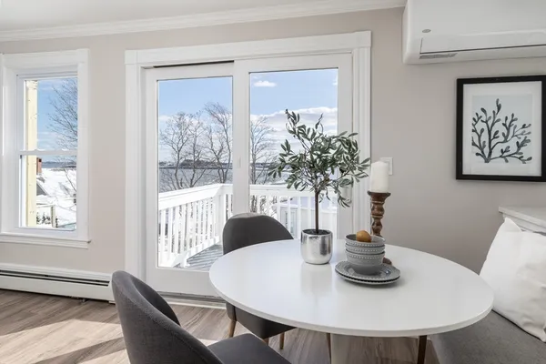 a view of a dining room with furniture window and wooden floor