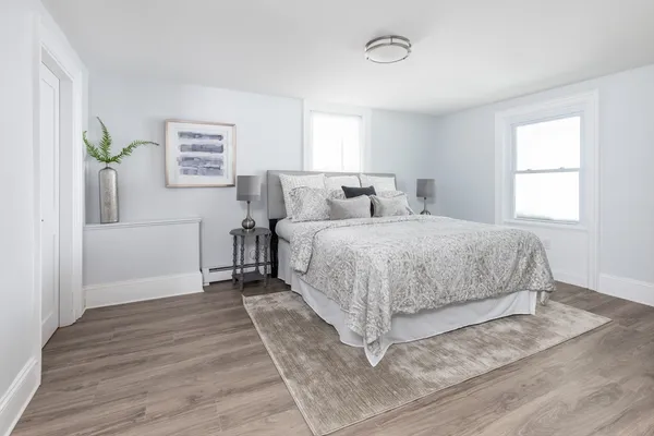 a bedroom with a large bed and a window