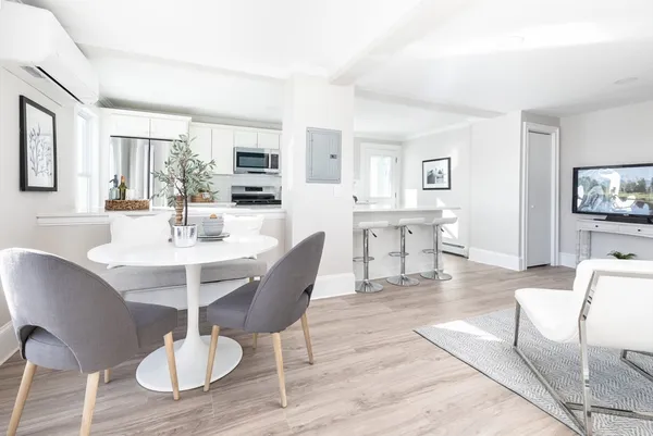 a view of a dining room with furniture and wooden floor