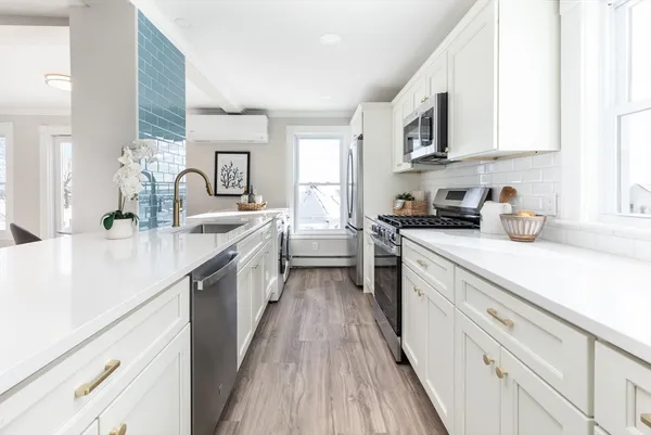 a kitchen with stainless steel appliances a sink dishwasher stove microwave and cabinets